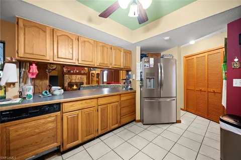 a kitchen with stainless steel appliances granite countertop a refrigerator a oven a sink with island and cabinets