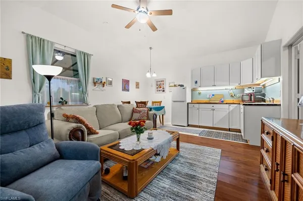 a living room with furniture and a kitchen view
