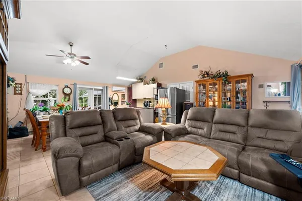 a living room with furniture a rug and a chandelier