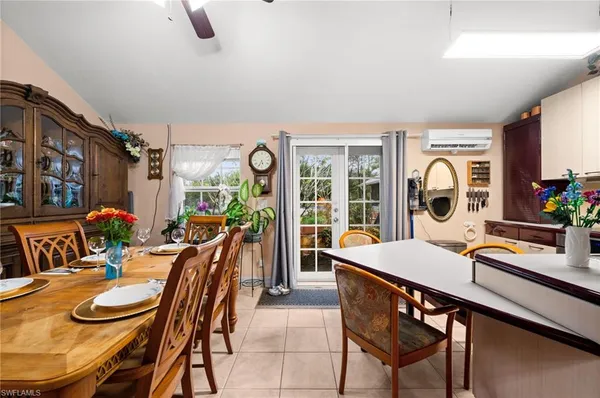 a dining room with furniture and a floor to ceiling window