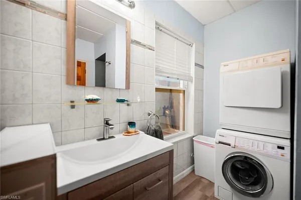 a bathroom with a sink a toilet and mirror