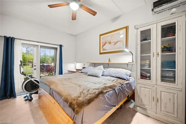 a bedroom with a bed and a large window with outer view