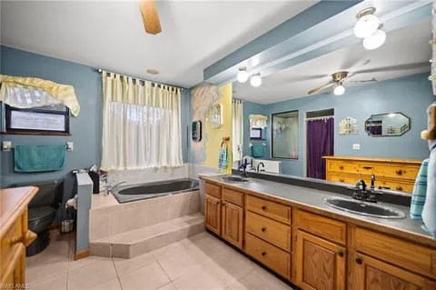 a spacious bathroom with a granite countertop sink and a large mirror