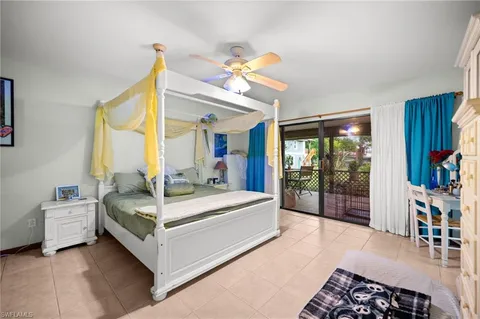 a spacious bedroom with a bed and a chandelier