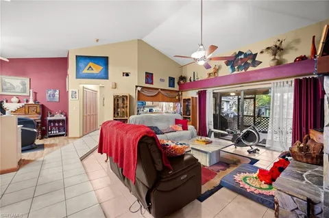 a bedroom with furniture and a large window
