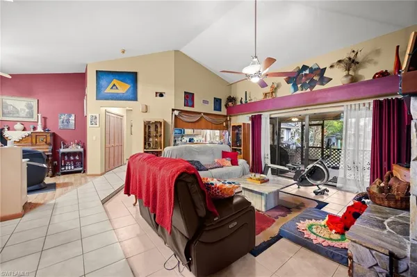 a bedroom with furniture and a large window