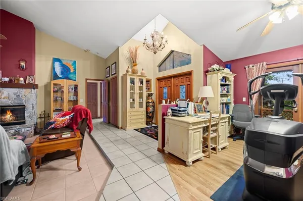 a living room with furniture gym equipment and a fireplace