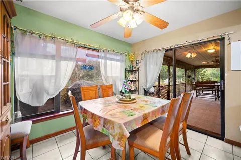 a dining room with furniture a chandelier and wooden floor