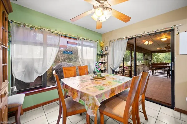 a dining room with furniture a chandelier and wooden floor