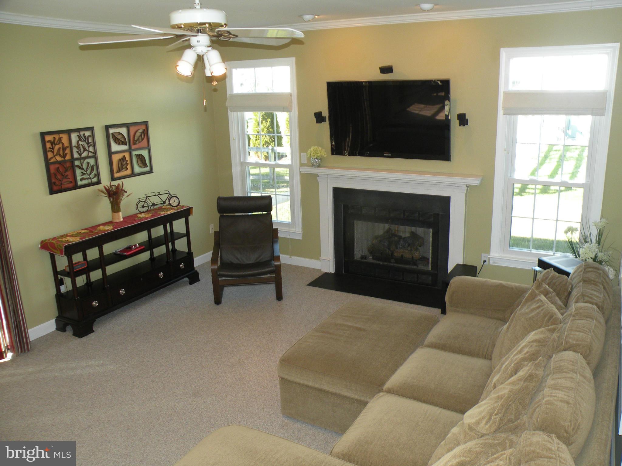 3231 Breckenridge Way Riva, MD 21140 - Photo 4 of 30 a living room with furniture a flat screen tv and a fireplace