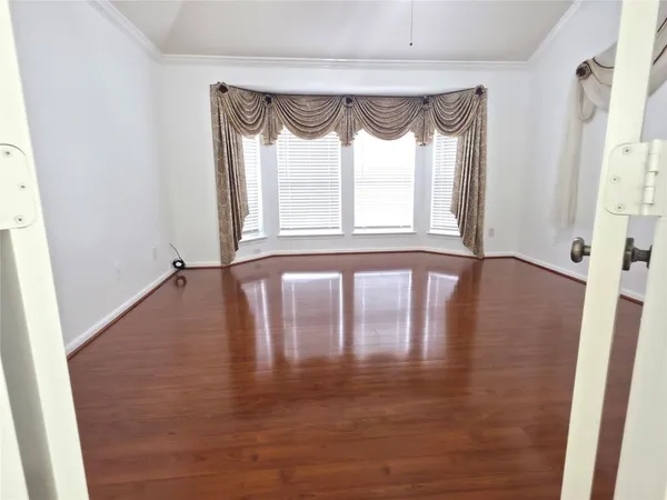 a spacious bathroom with a tub sink and mirror