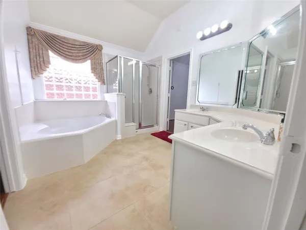 an empty room with wooden floor cabinet and windows