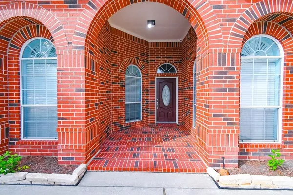 a front view of a house with large windows