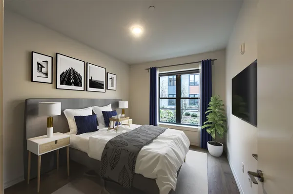 a bedroom with a balcony a bed and a flat screen tv