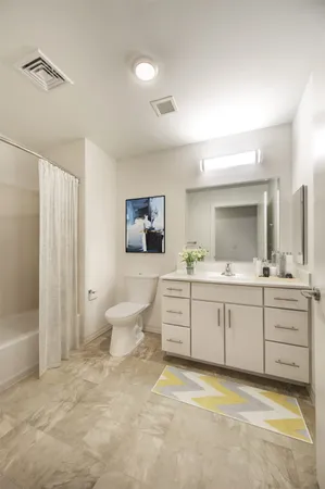 a bathroom with a granite countertop sink mirror and bathtub