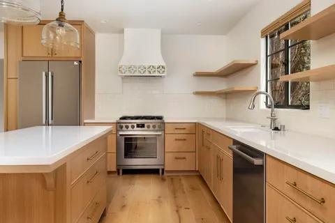 a kitchen with stainless steel appliances a sink stove and refrigerator