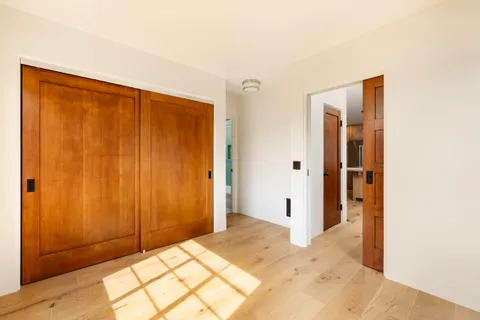 a view of a livingroom with wooden floor and cabinet
