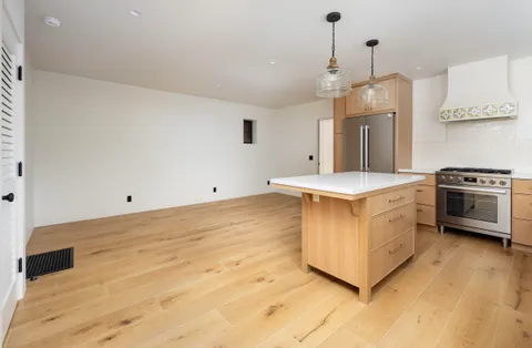 a kitchen with a stove a sink and a refrigerator