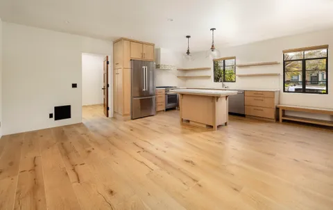 a kitchen with stainless steel appliances a refrigerator and a stove top oven
