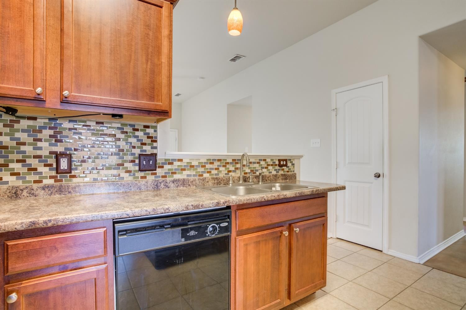 6921 95th Street Lubbock, TX 79424 - Photo 12 of 32 a kitchen with granite countertop stainless steel appliances sink and cabinets