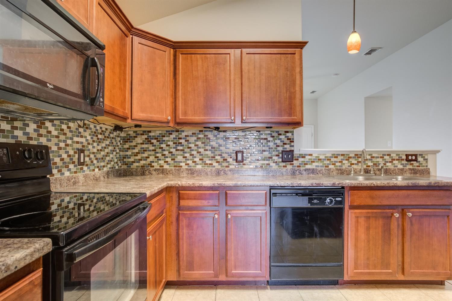 6921 95th Street Lubbock, TX 79424 - Photo 14 of 32 a kitchen with stainless steel appliances granite countertop a sink and a stove