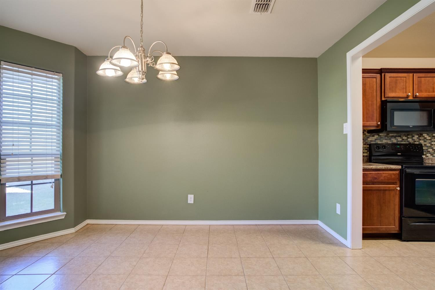 6921 95th Street Lubbock, TX 79424 - Photo 15 of 32 a view of kitchen with window and refrigerator