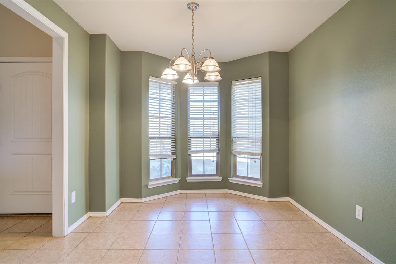 6921 95th Street Lubbock, TX 79424 - Photo 17 of 32 a view of an empty room with a window