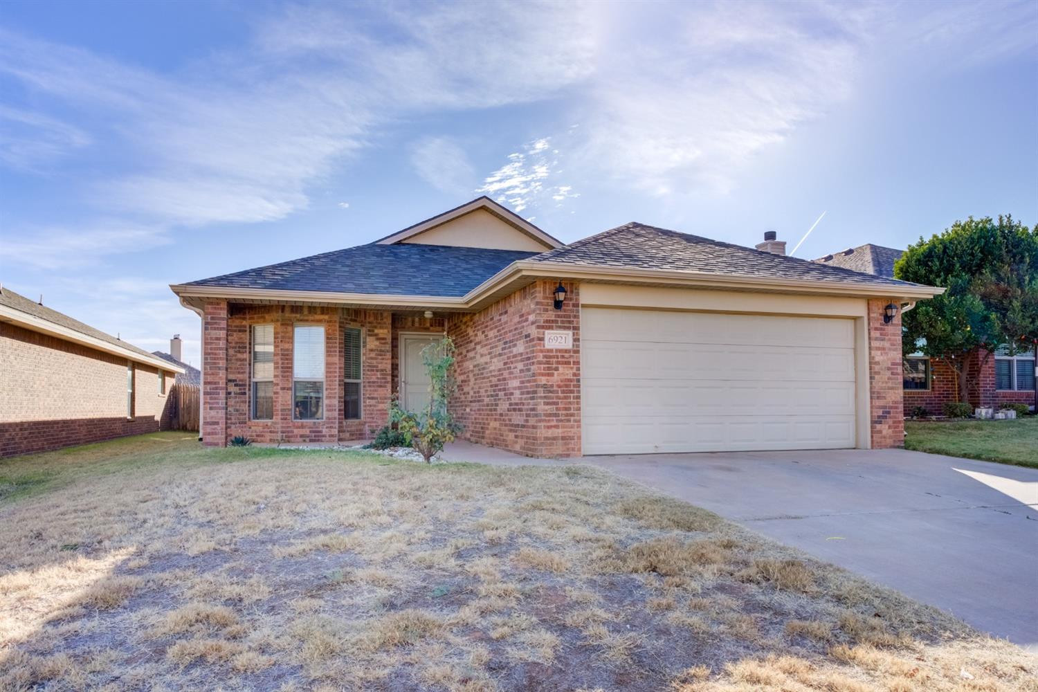 6921 95th Street Lubbock, TX 79424 - Photo 2 of 32 front view of a house with a yard