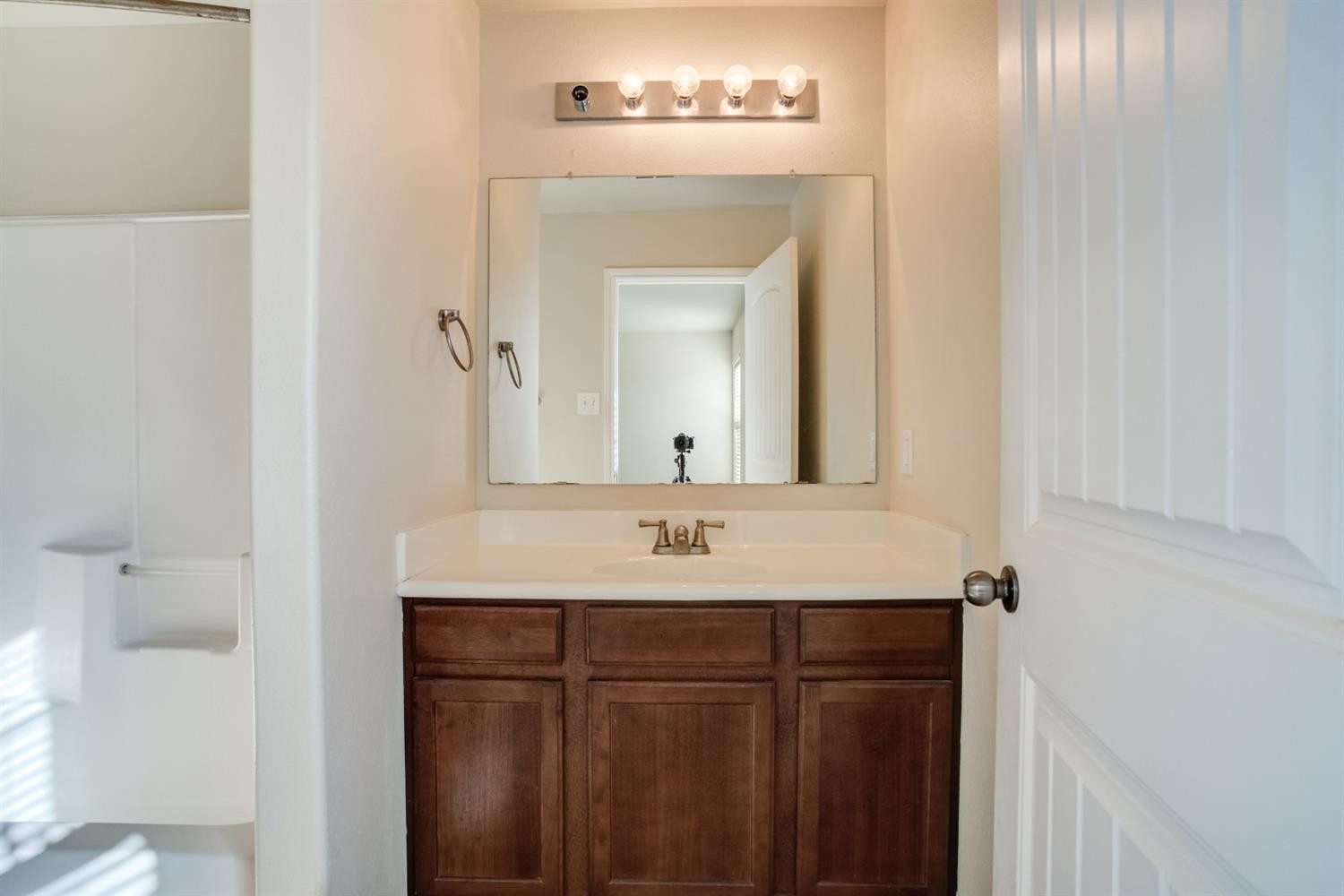 6921 95th Street Lubbock, TX 79424 - Photo 23 of 32 a bathroom with a granite countertop sink and a mirror