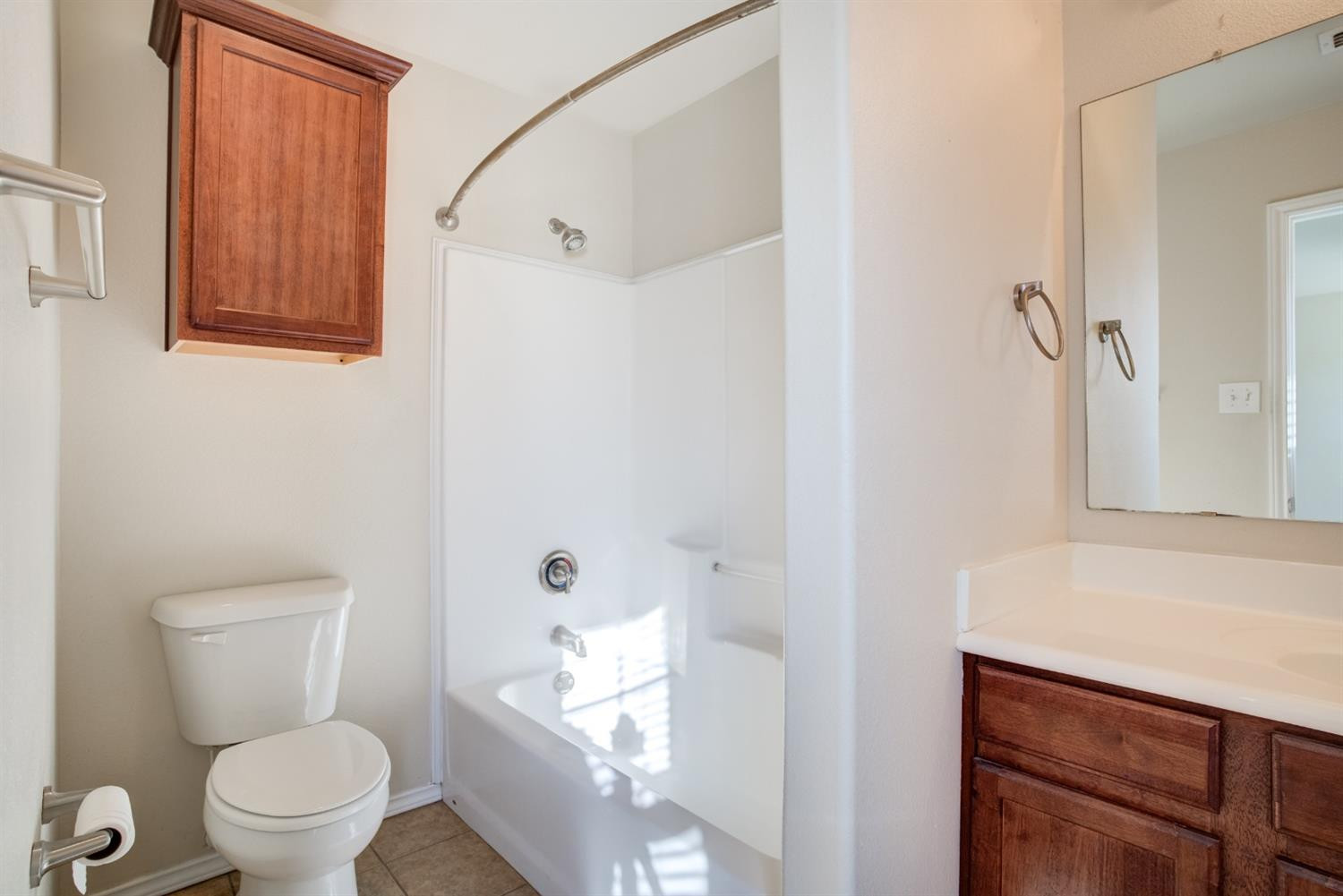 6921 95th Street Lubbock, TX 79424 - Photo 24 of 32 a white toilet sitting next to a bathroom sink