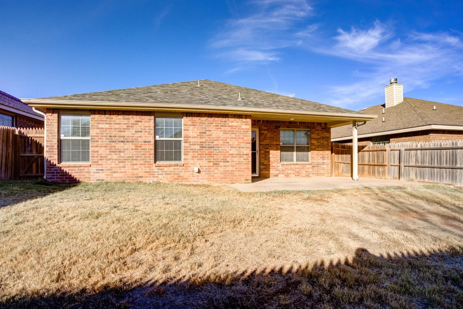 6921 95th Street Lubbock, TX 79424 - Photo 31 of 32 a front view of a house with a yard