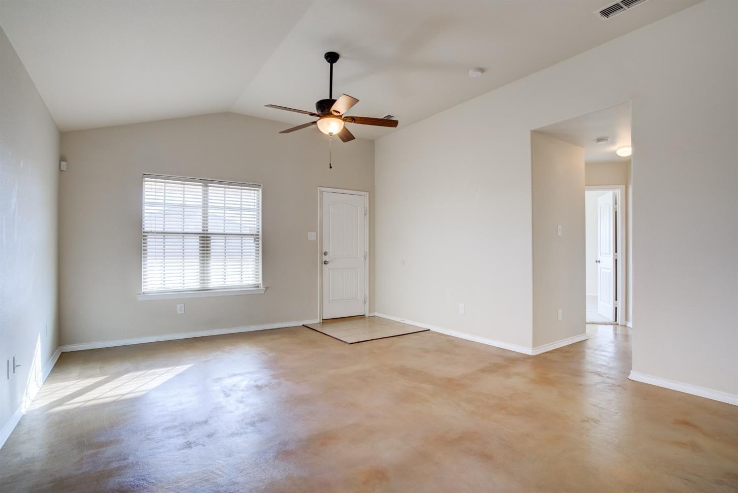 6921 95th Street Lubbock, TX 79424 - Photo 5 of 32 an empty room with windows and fan