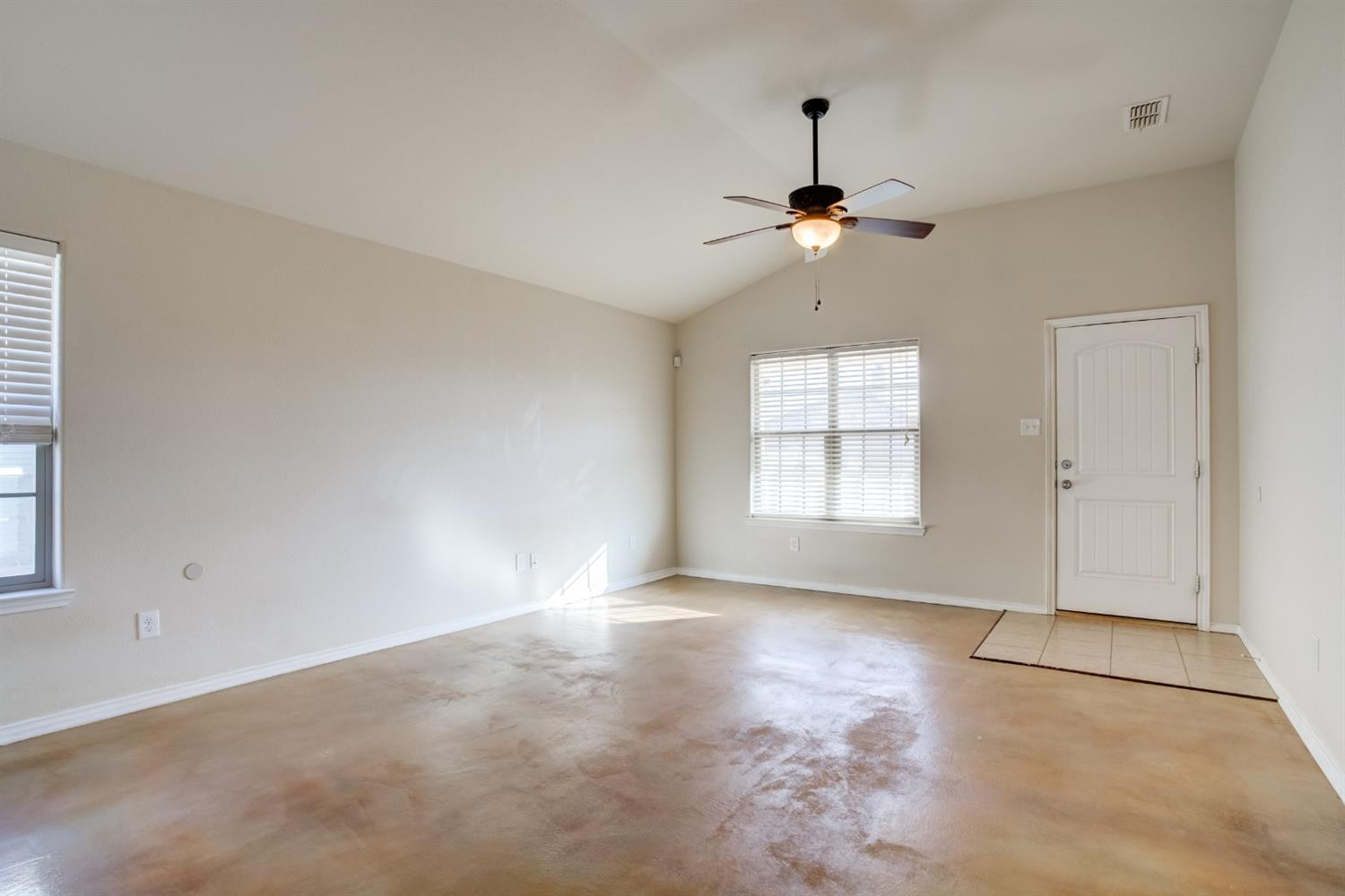 6921 95th Street Lubbock, TX 79424 - Photo 6 of 32 a view of a room with a ceiling fan and window