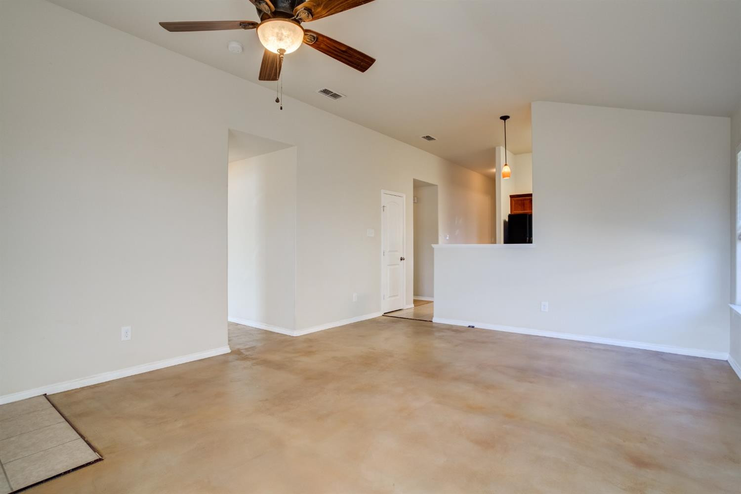 6921 95th Street Lubbock, TX 79424 - Photo 7 of 32 a view of an empty room with a ceiling fan
