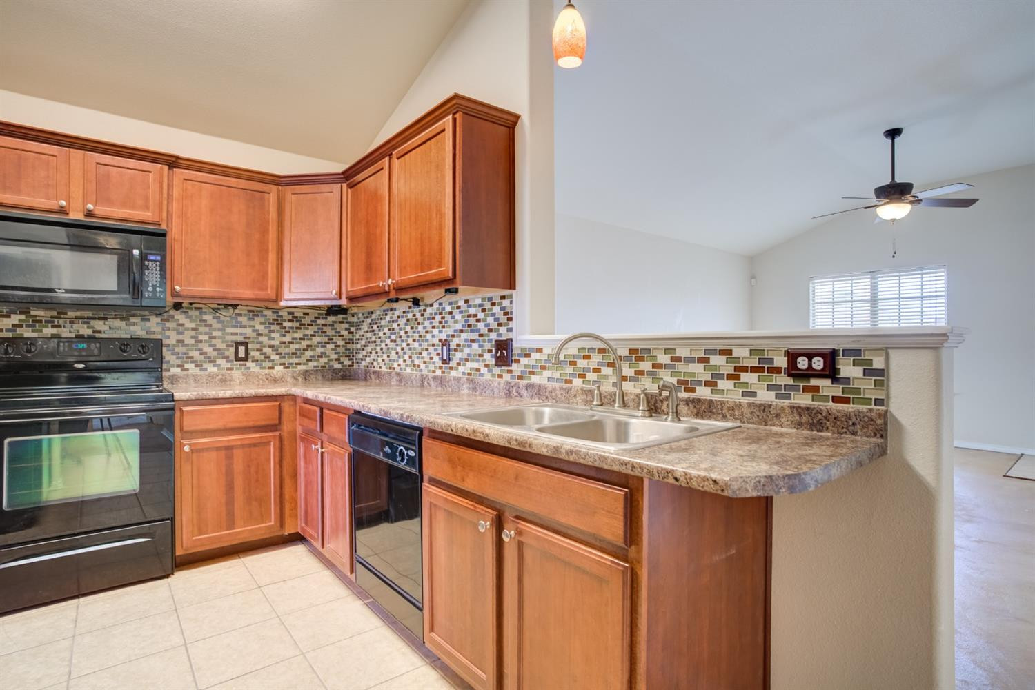 6921 95th Street Lubbock, TX 79424 - Photo 10 of 32 a kitchen with stainless steel appliances granite countertop a sink stove and microwave