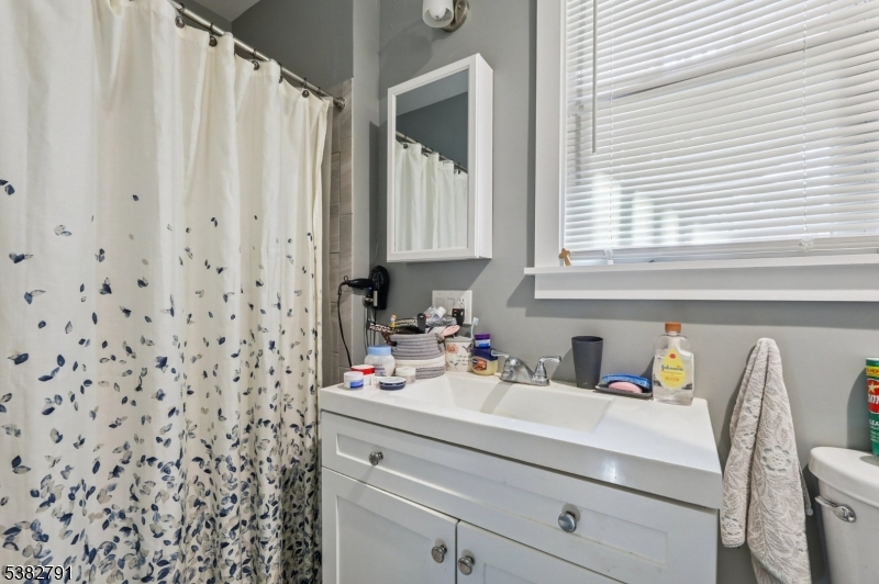 57 Greenwood Avenue Madison, NJ 07940 - Photo 16 of 30 a bathroom with a sink a vanity and a window