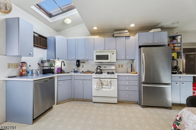 57 Greenwood Avenue Madison, NJ 07940 - Photo 18 of 30 a kitchen with cabinets stainless steel appliances a sink and a refrigerator