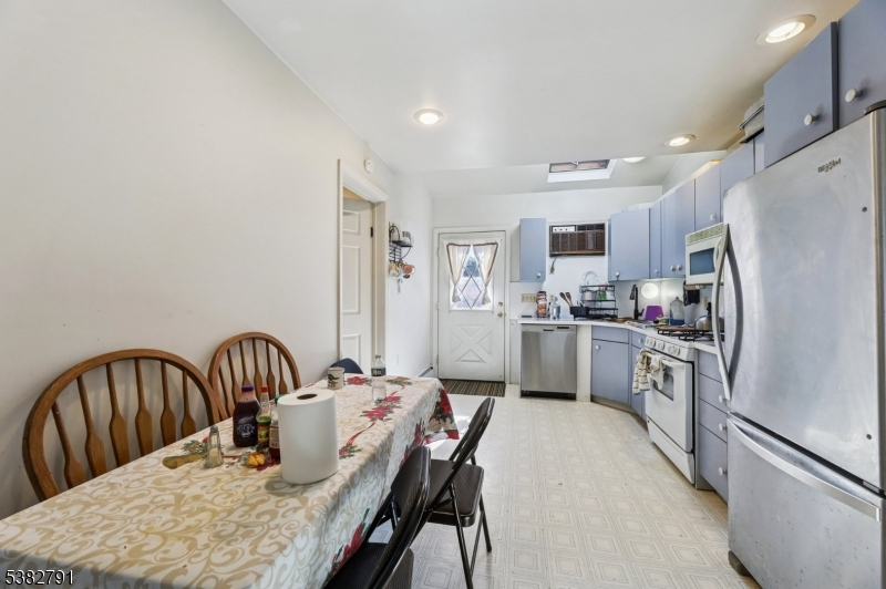 57 Greenwood Avenue Madison, NJ 07940 - Photo 19 of 30 a kitchen with granite countertop a refrigerator a sink a stove a dining table and chairs