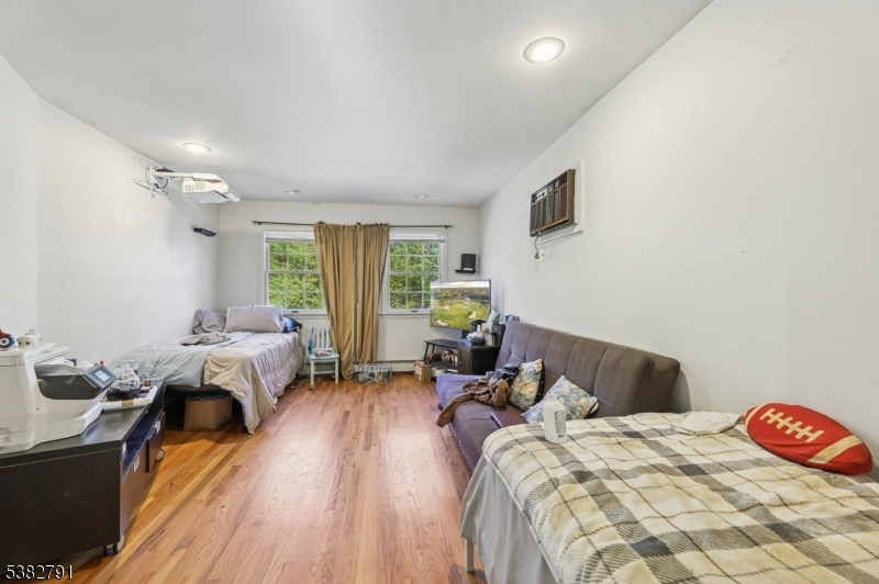 57 Greenwood Avenue Madison, NJ 07940 - Photo 20 of 30 a bedroom with a bed and wooden floor