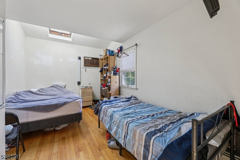 57 Greenwood Avenue Madison, NJ 07940 - Photo 24 of 30 a bedroom with a bed and wooden floor