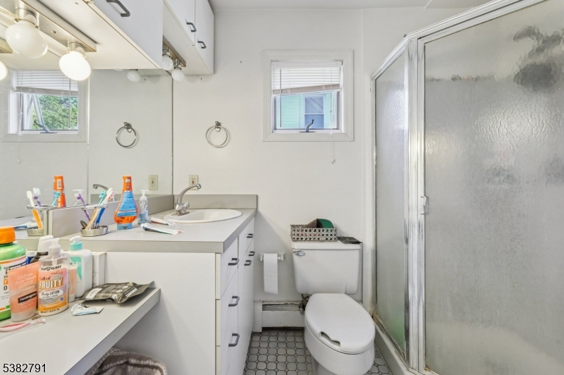 57 Greenwood Avenue Madison, NJ 07940 - Photo 26 of 30 a bathroom with a sink toilet vanity and a mirror