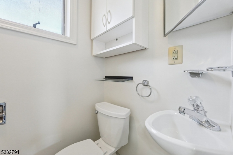 57 Greenwood Avenue Madison, NJ 07940 - Photo 30 of 30 a white toilet sitting next to a bathroom sink
