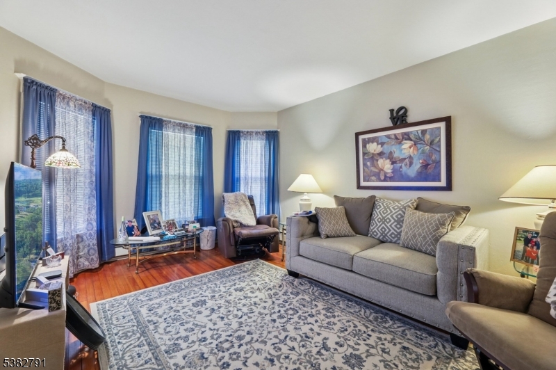 57 Greenwood Avenue Madison, NJ 07940 - Photo 9 of 30 a living room with furniture a rug and a lamp