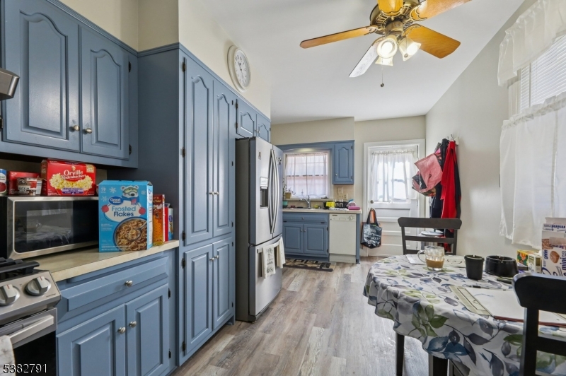 57 Greenwood Avenue Madison, NJ 07940 - Photo 10 of 30 a kitchen with stainless steel appliances granite countertop a refrigerator a stove microwave and cabinets with wooden floor