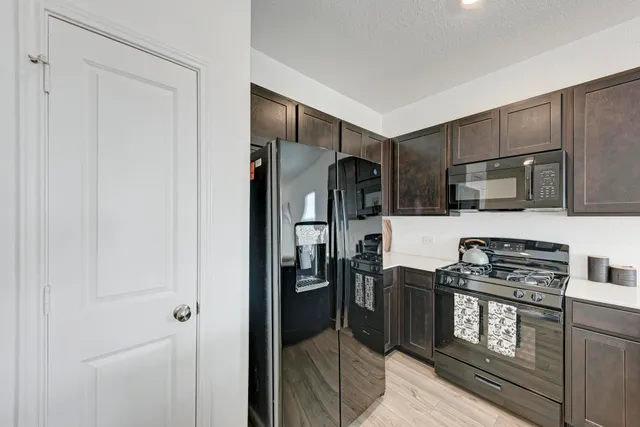a large kitchen with a large counter top appliances and cabinets