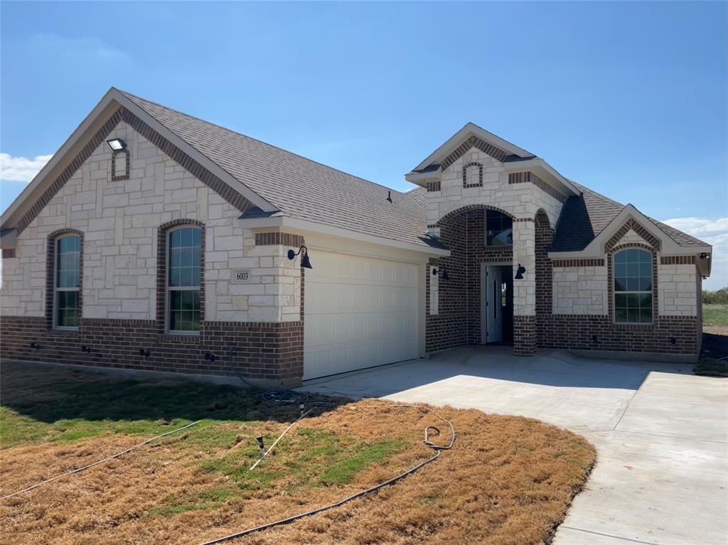 8008 County Road 1058 Rice, TX 75155 - Photo 3 of 25 Stone and brick façade featuring arched entryway and arched windows