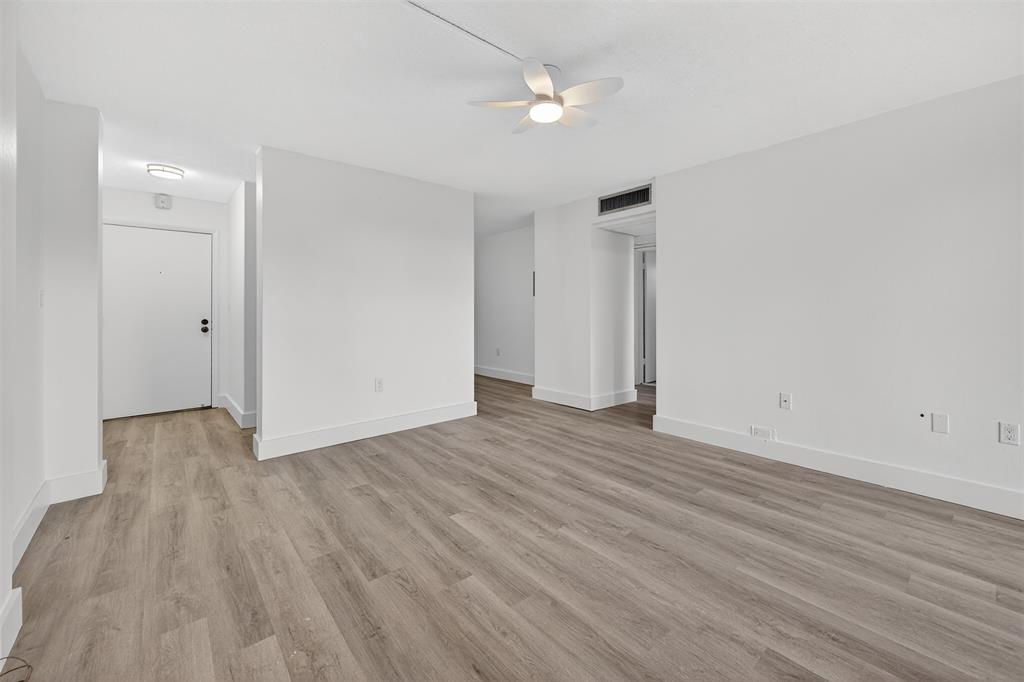 2465 Southwest 18th Avenue, Unit 3206 Miami, FL 33133 - Photo 12 of 21 an empty room with wooden floor and ceiling fan