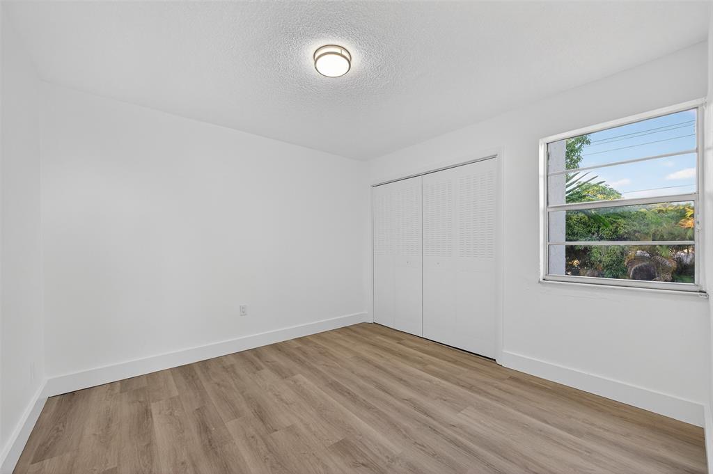 2465 Southwest 18th Avenue, Unit 3206 Miami, FL 33133 - Photo 16 of 21 wooden floor in an empty room with a window