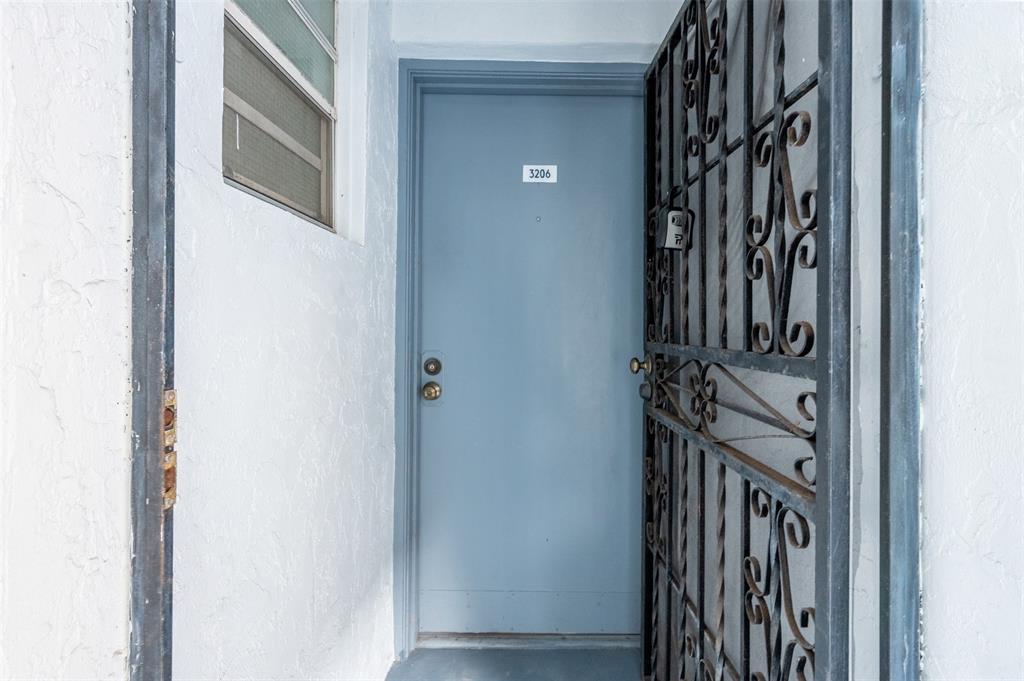 2465 Southwest 18th Avenue, Unit 3206 Miami, FL 33133 - Photo 4 of 21 a view of a hallway with a door and stairs