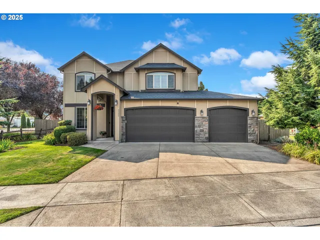 a front view of a house with a yard and garage